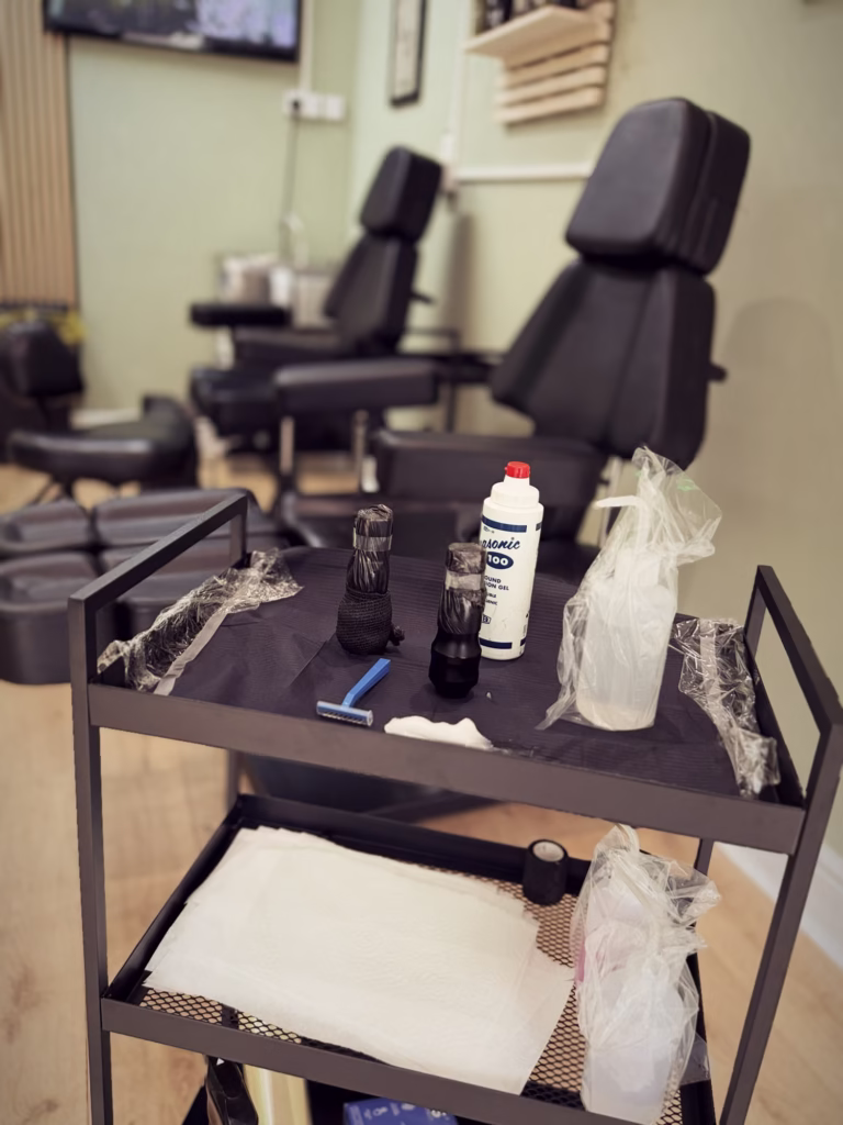 Tattoo station prepared with ink, gloves and equipment at The Viper Pit, ready for the next client.