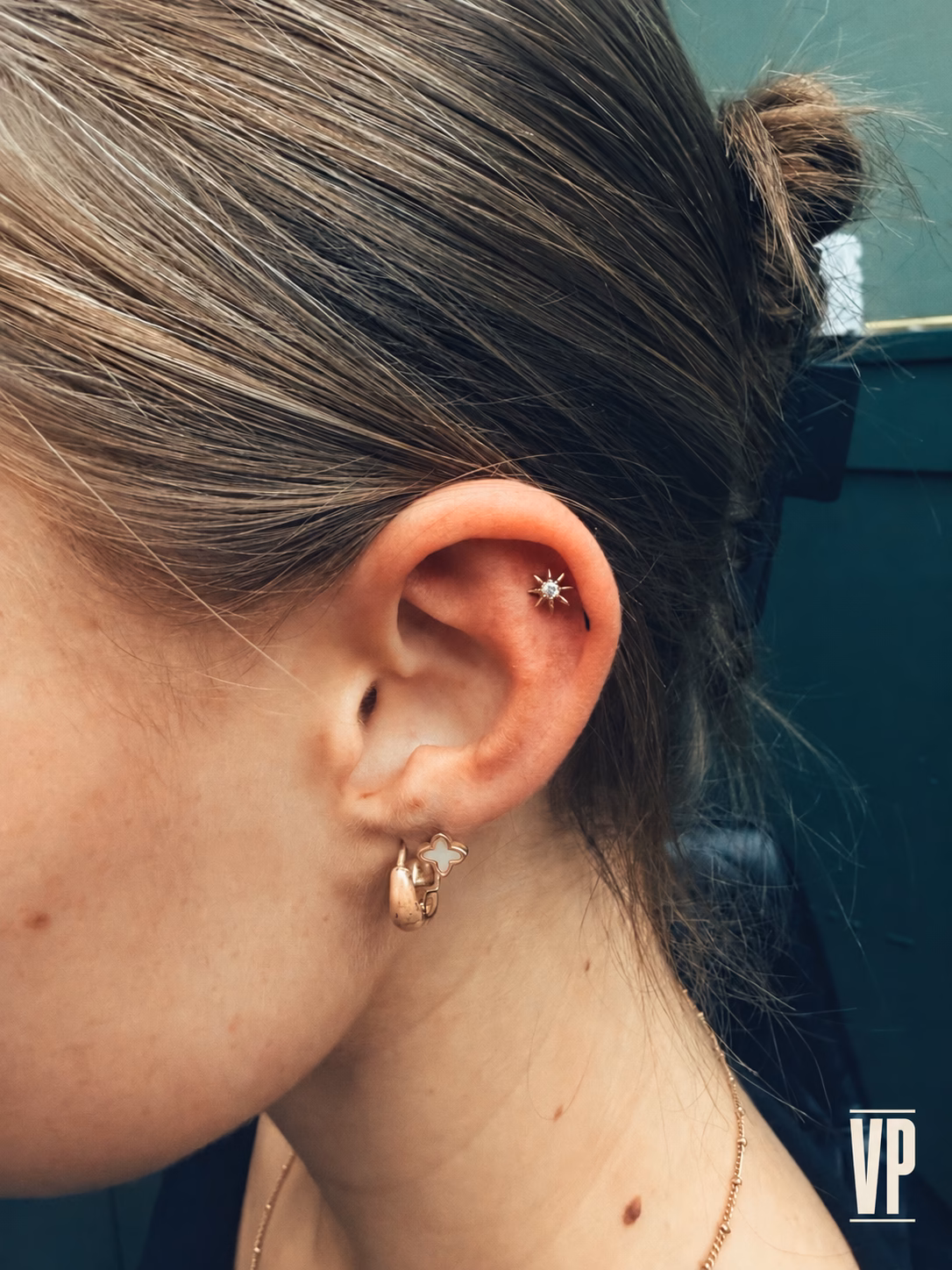 Flat or Helix Piercing? How to Choose Before Booking in Irlam 1 Upper ear cartilage piercing with star-shaped jewellery and VP logo at The Viper Pit in Irlam